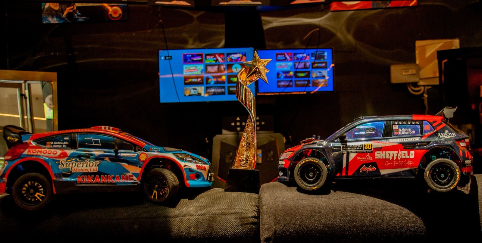 Championship trophy and rally cars, 2025